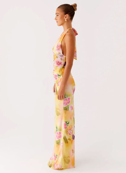 Side profile of halter midi dress with flowing skirt and floral print