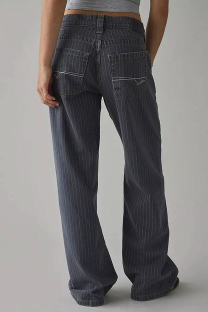 Back view of dark indigo wide-leg jeans with five-pocket construction and decorative stitching