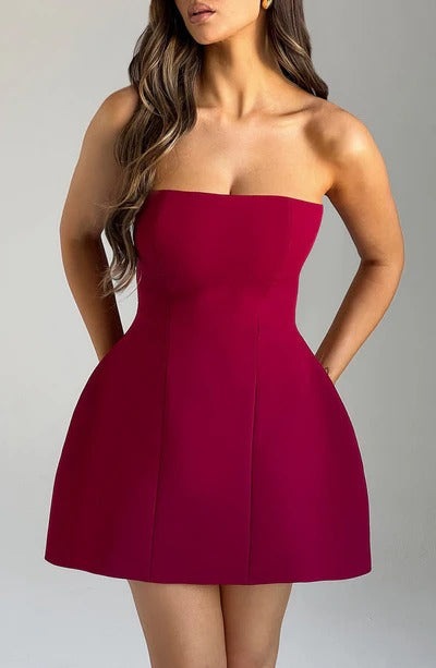 Blush pink strapless mini dress with fitted bodice and flared hem