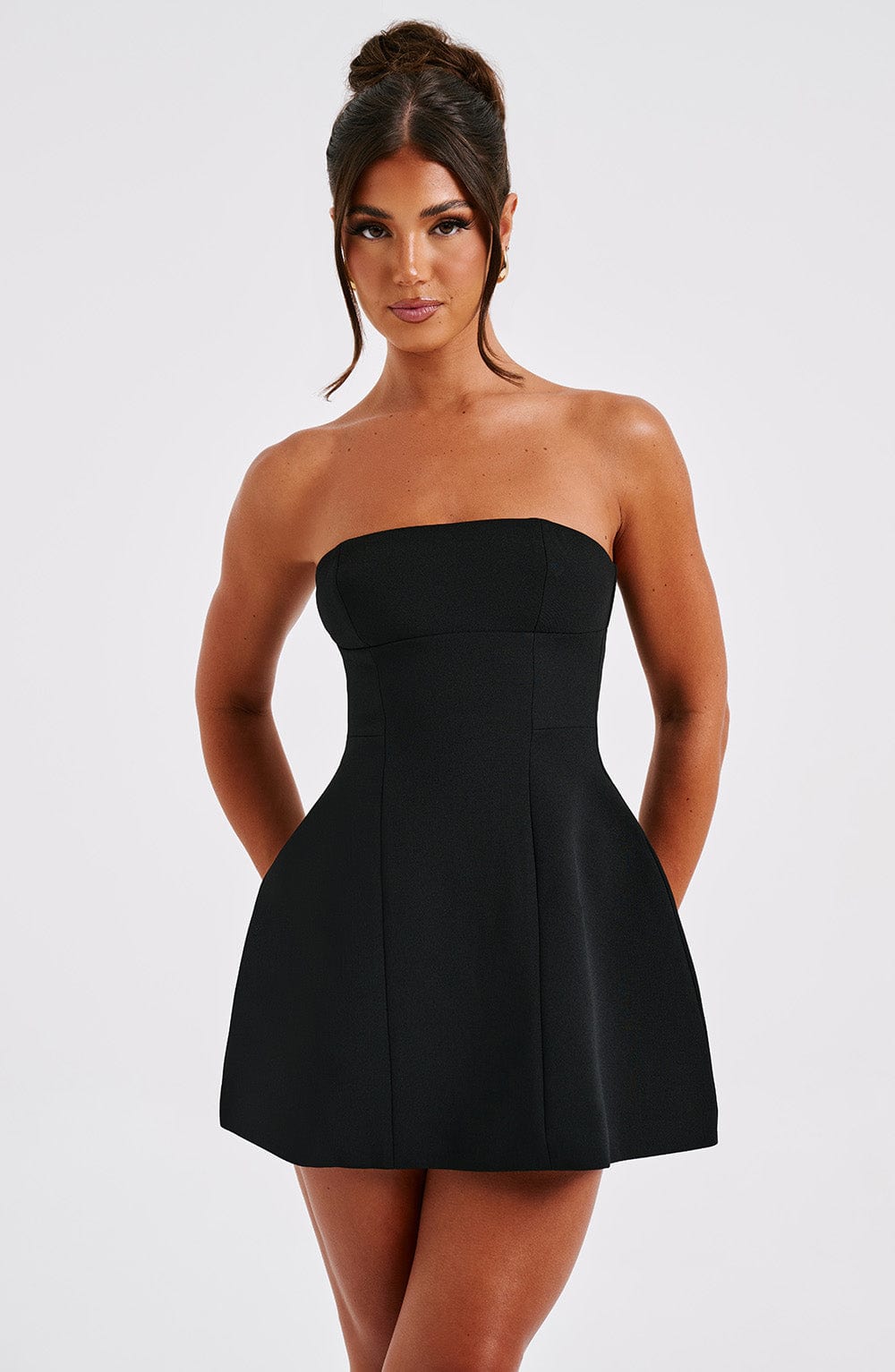 Black strapless mini dress front view showing fitted bodice and full skirt