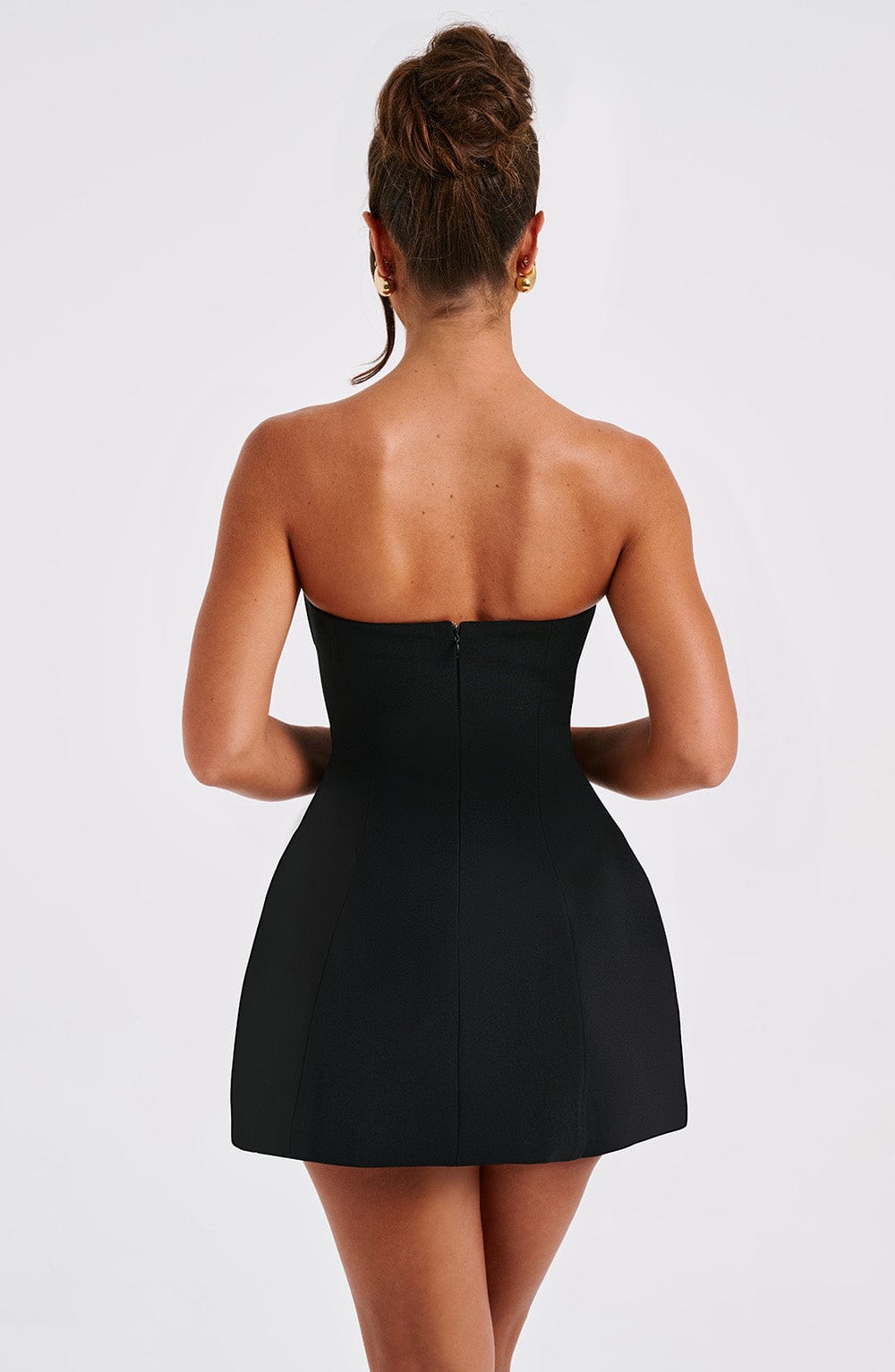 Black strapless mini dress back view showing center seam detail