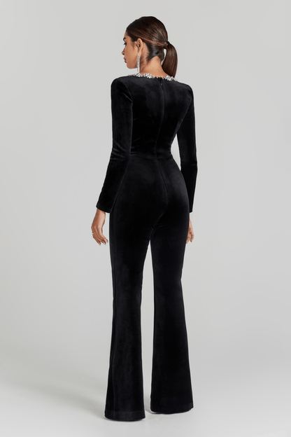 Back view of black velvet jumpsuit with long sleeves and flared pants