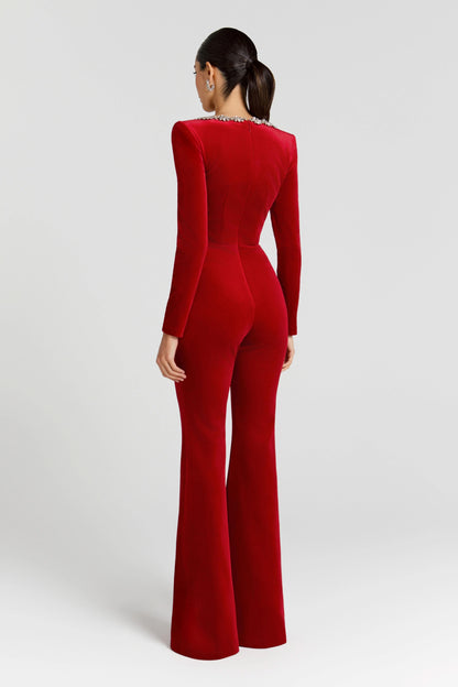 Back view of red velvet jumpsuit with long sleeves and flared silhouette
