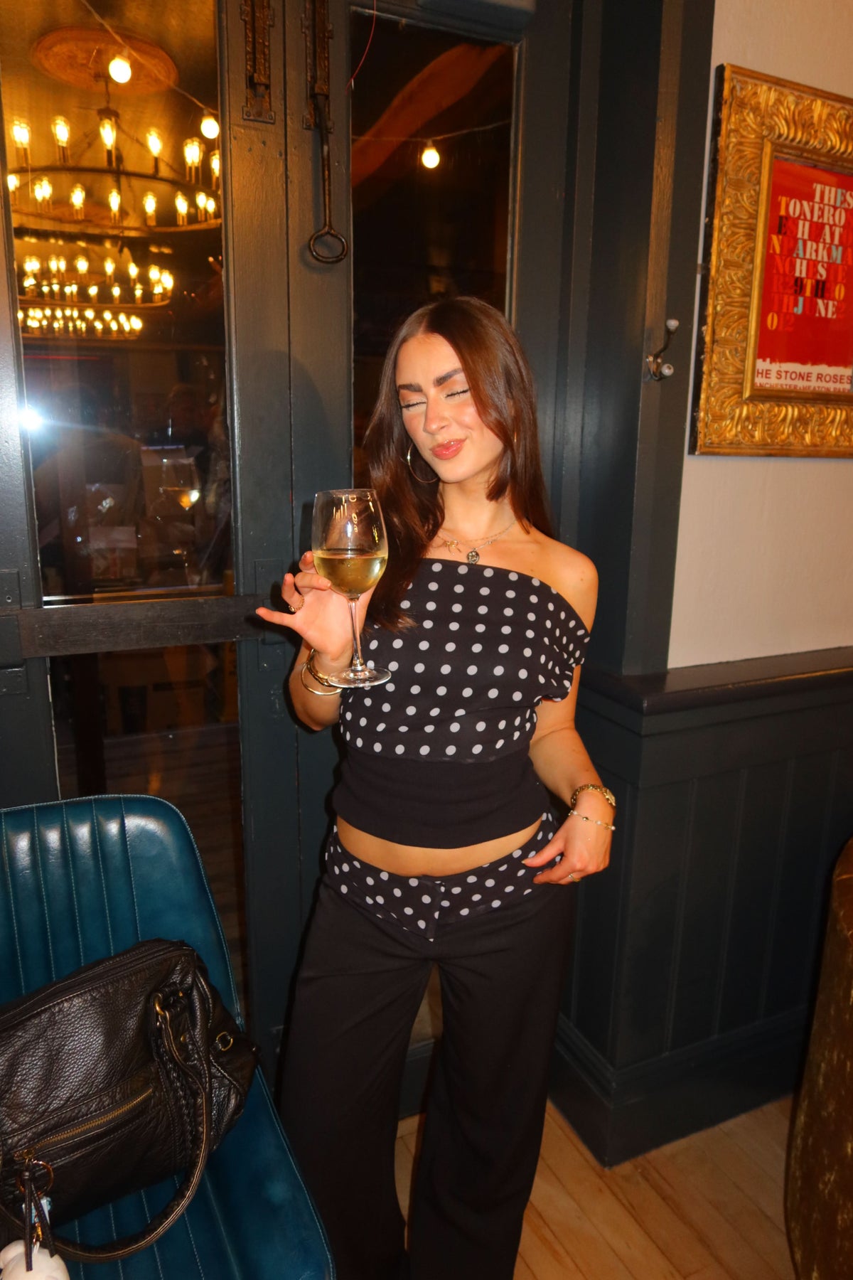 Black polka dot off-shoulder crop top with white dots and black ribbed waistband