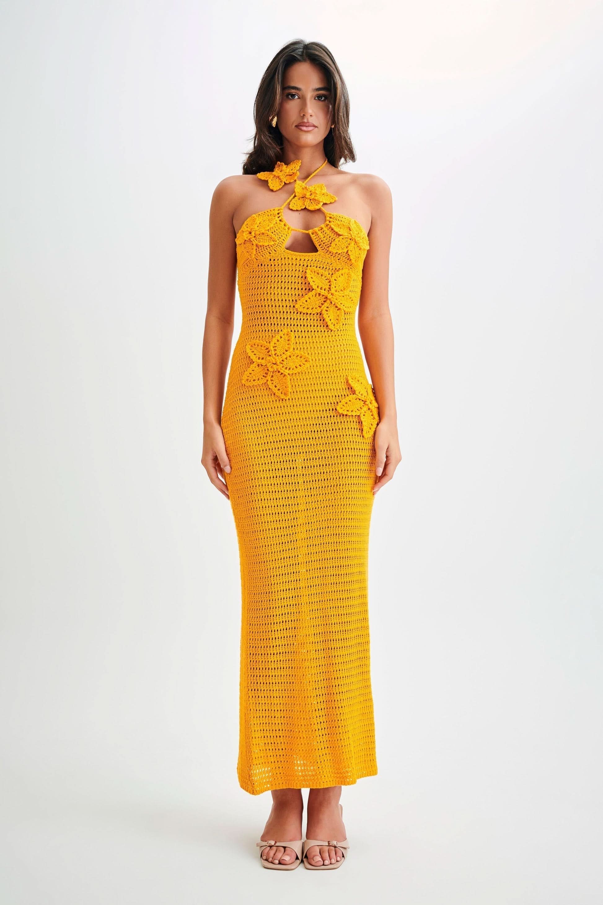 Golden yellow crochet maxi dress with halter neckline and decorative butterfly appliqués