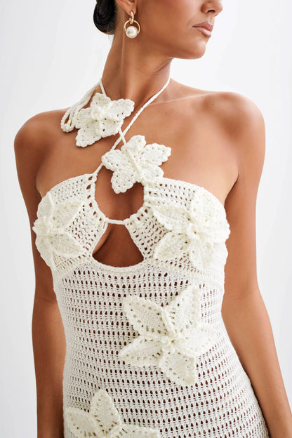 Close-up of cream crochet halter neckline with white flower details