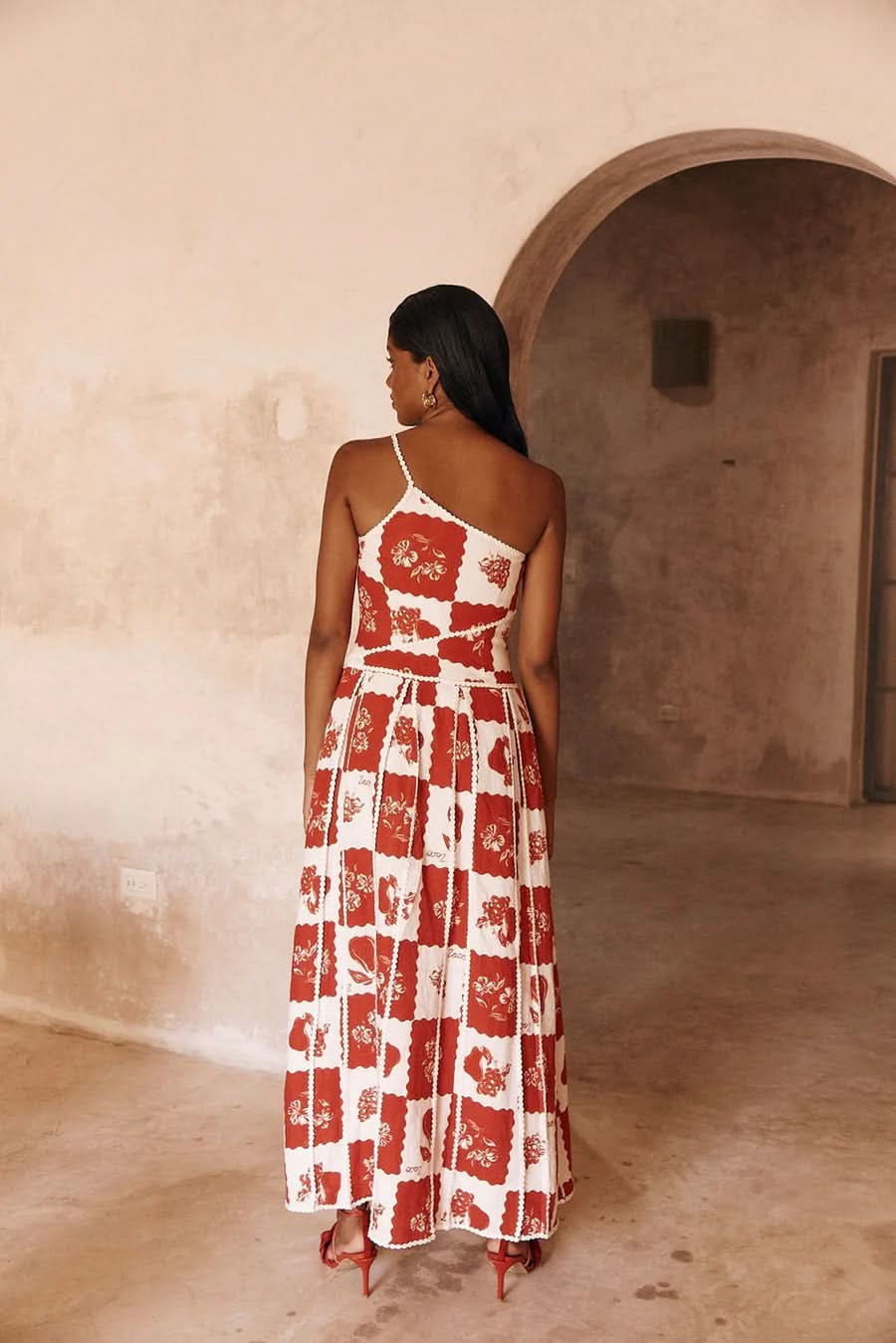 Side view of red and white maxi dress with wrapped waist detail