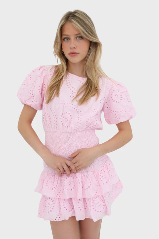 Pink eyelet mini dress with short puffed sleeves and smocked waist detail