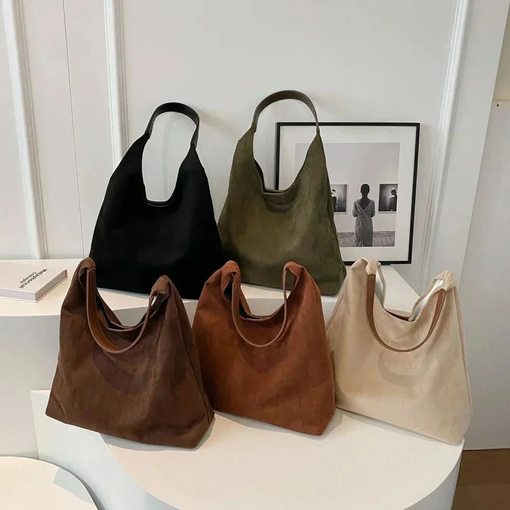 Collection of suede tote bags in brown, cognac, cream, black, and olive