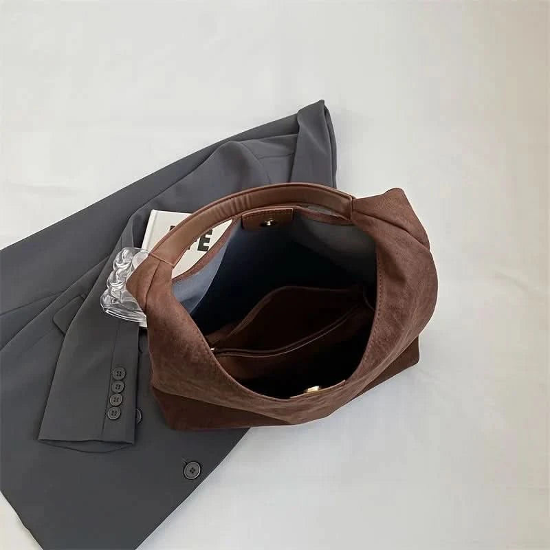 Open brown suede tote showing spacious interior compartment