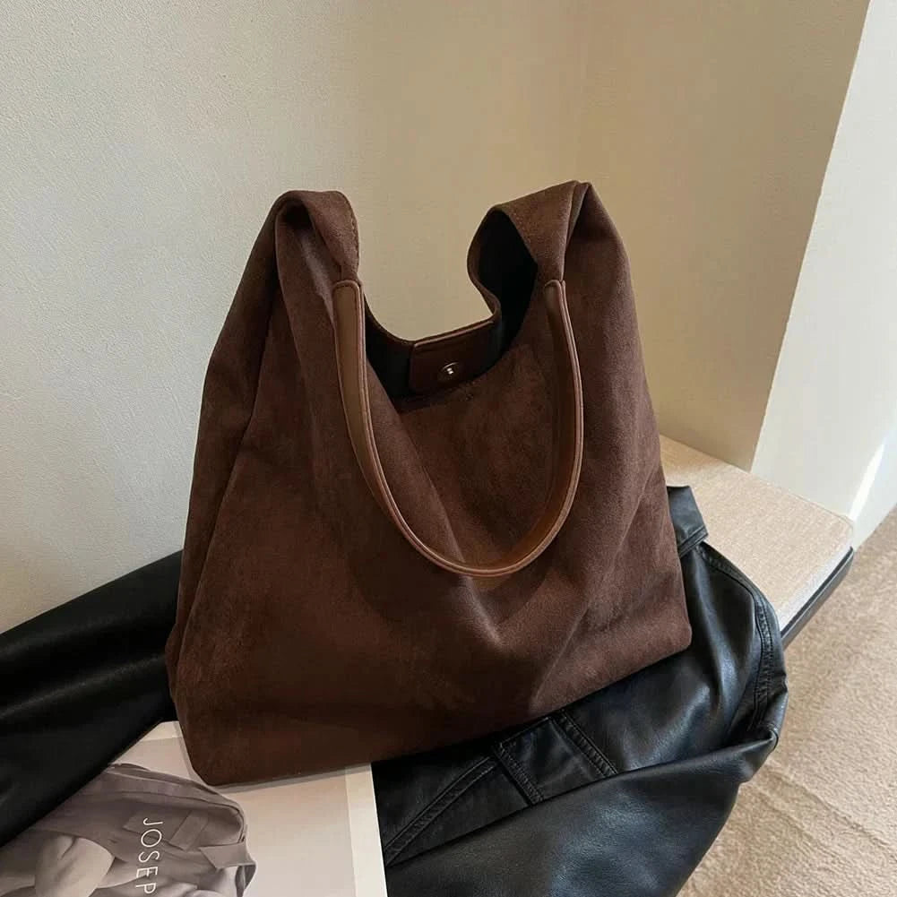 Dark brown suede tote bag with open top and structured shape