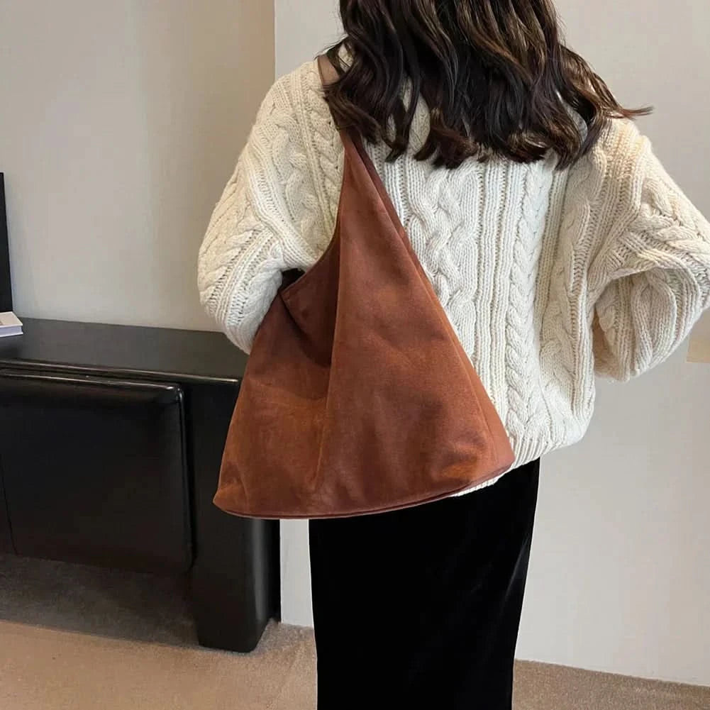 Rust brown suede tote bag with handles worn over shoulder