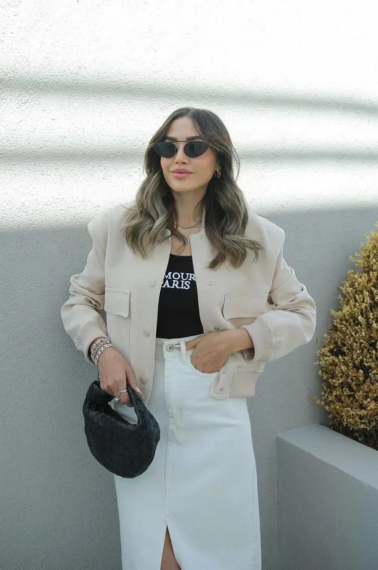 Cream colored bomber jacket with patch pockets and white skirt