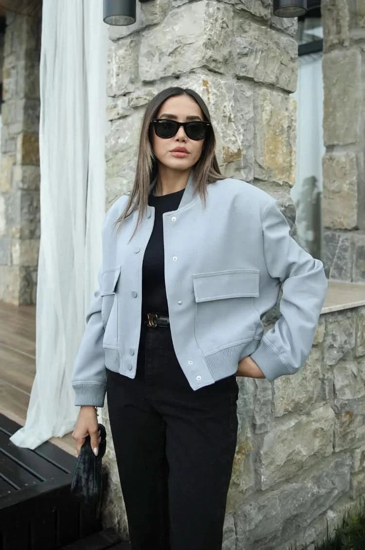 Light gray bomber jacket with button front and black pants