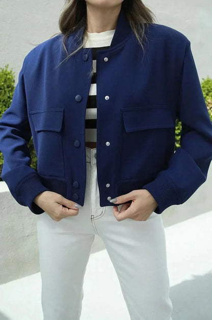 Navy blue bomber jacket with button front and ribbed cuffs worn open