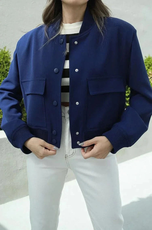 Navy blue bomber jacket with button front and ribbed cuffs worn open
