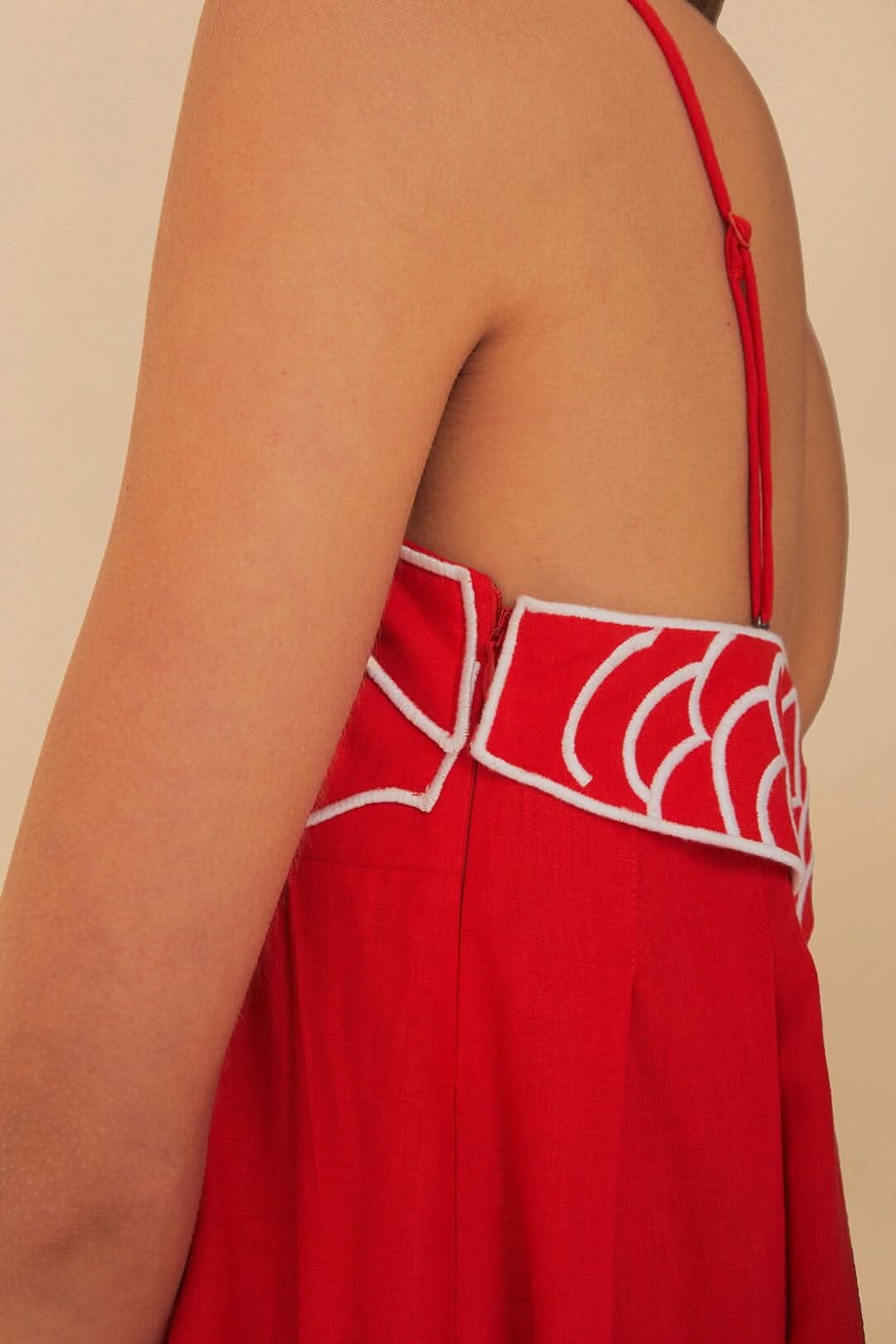 Close-up of white outlined koi fish design on red fabric