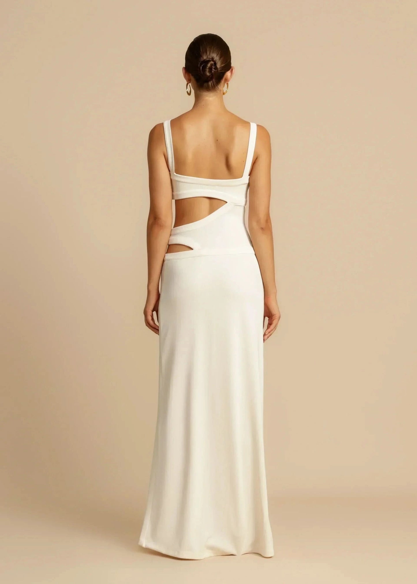 White sleeveless maxi dress with waist cutouts, full length back