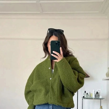 Olive green oversized bomber jacket with quilted texture and button front closure