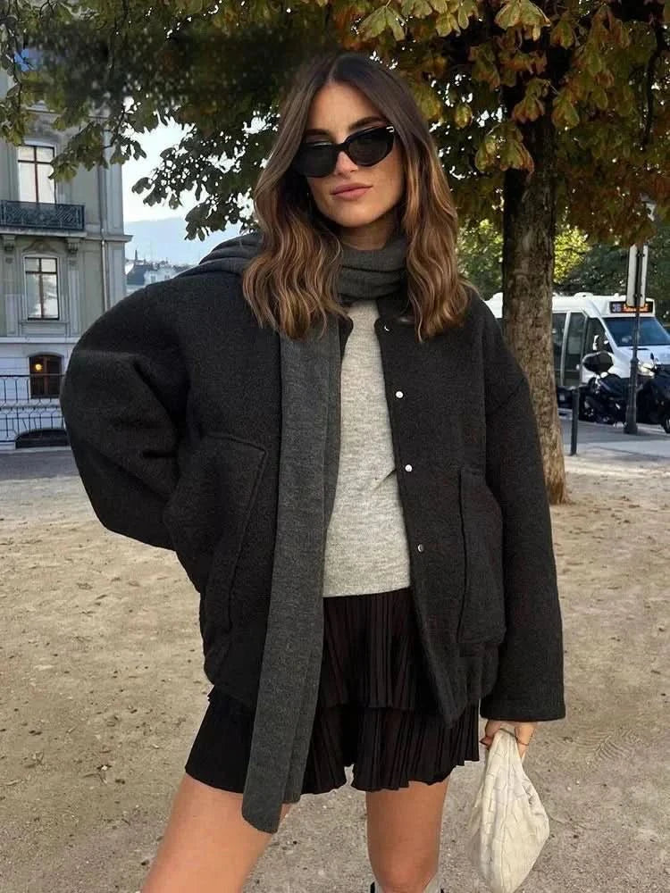 Black and charcoal color-block bomber jacket with cropped silhouette