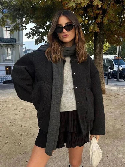 Black and charcoal color-block bomber jacket with cropped silhouette