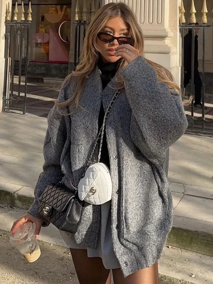 Olive green oversized bomber jacket with button closure and wide sleeves