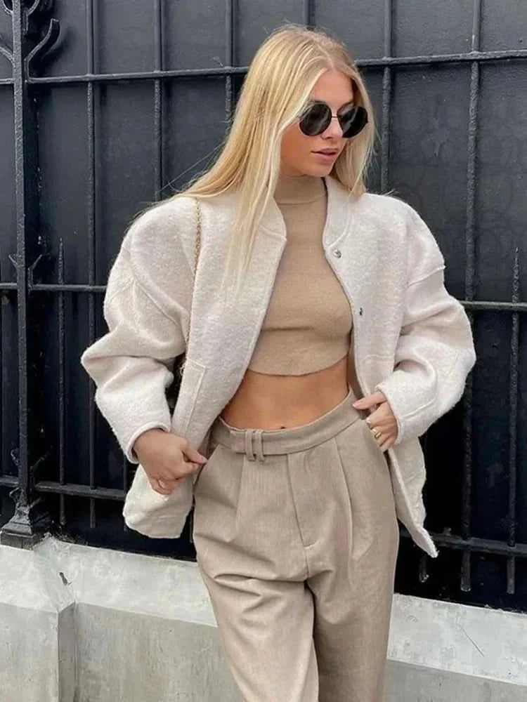 Cream cropped bomber jacket with snap front and boxy fit