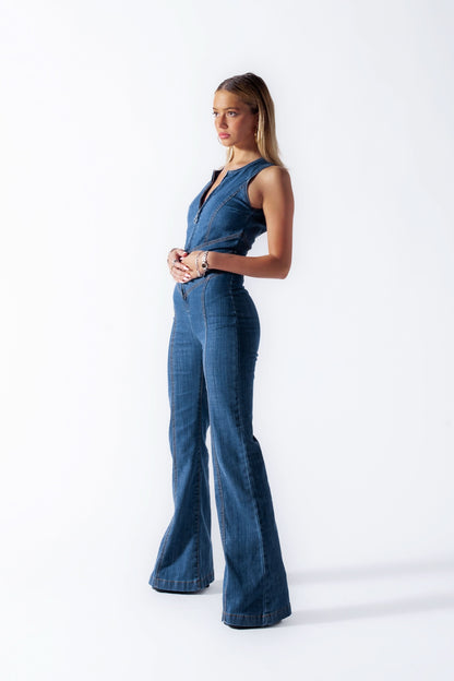 Side profile of sleeveless denim jumpsuit with cropped bodice and wide-leg pants