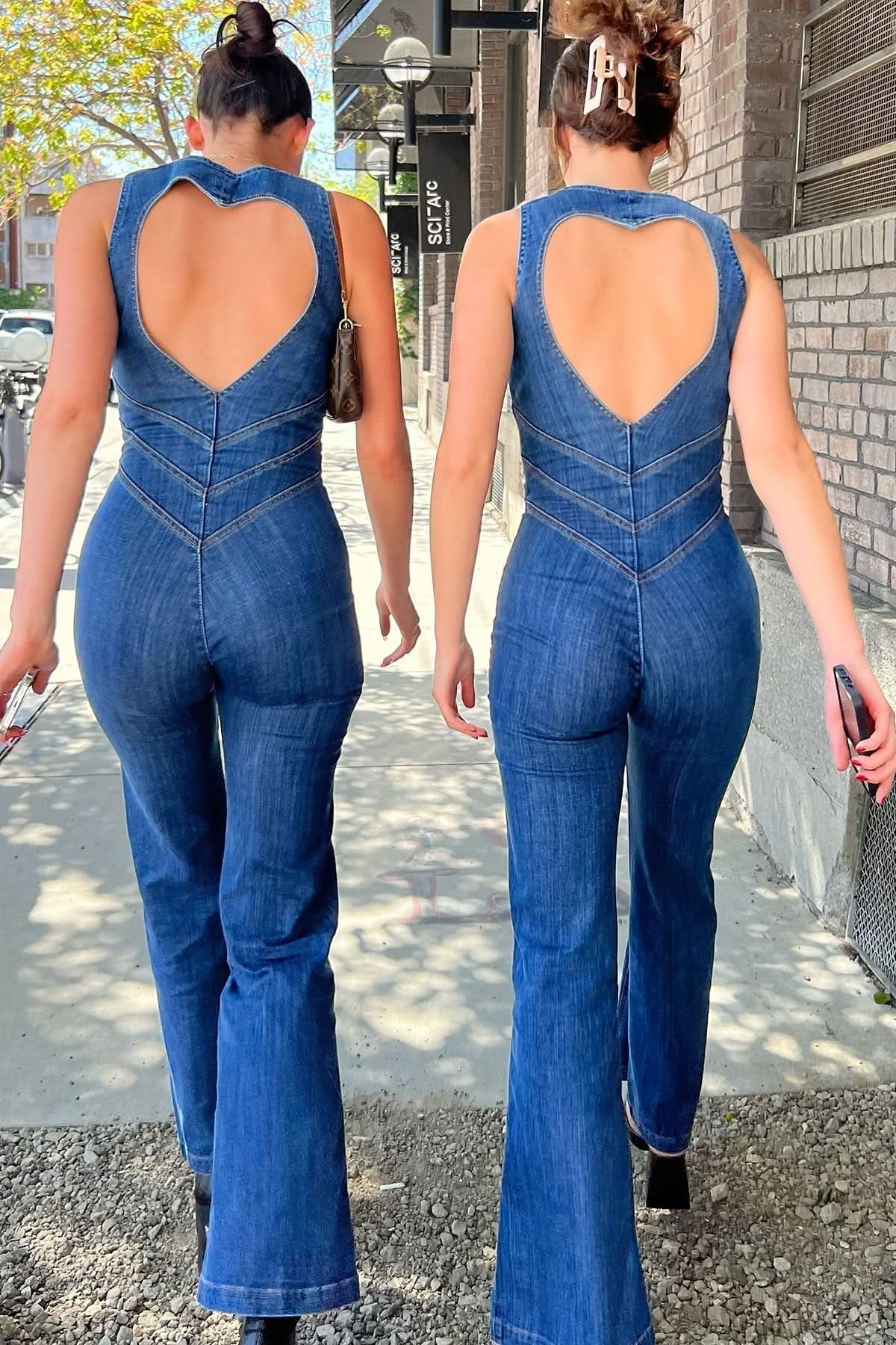 Blue denim jumpsuit with heart-shaped cutout back and chevron seaming detail