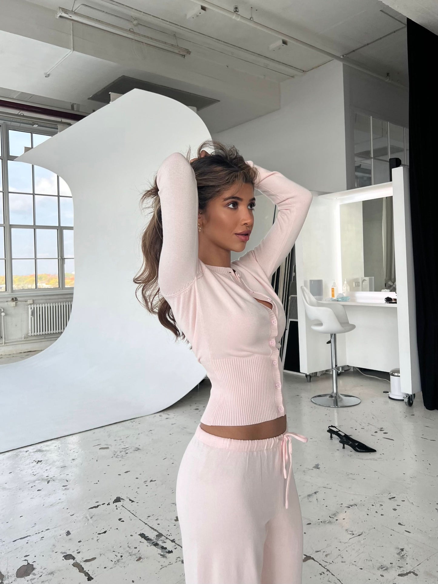 Pink cropped knit cardigan with ribbed texture and wide-leg pants