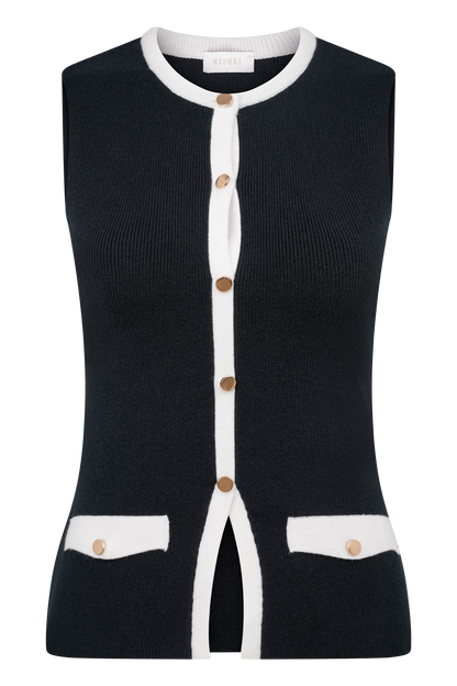 Black knit vest with white button front and patch pocket details