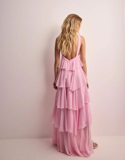 Back view of pink tiered maxi dress with open back and cascading ruffle layers