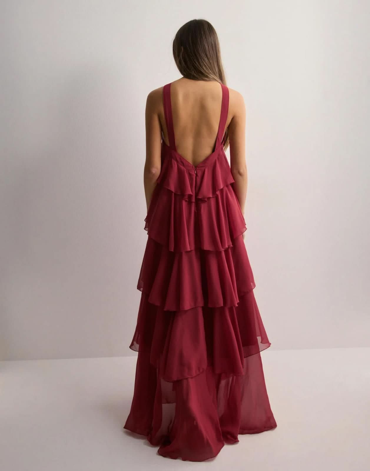 Burgundy maxi dress back view with open back design and tiered ruffled skirt