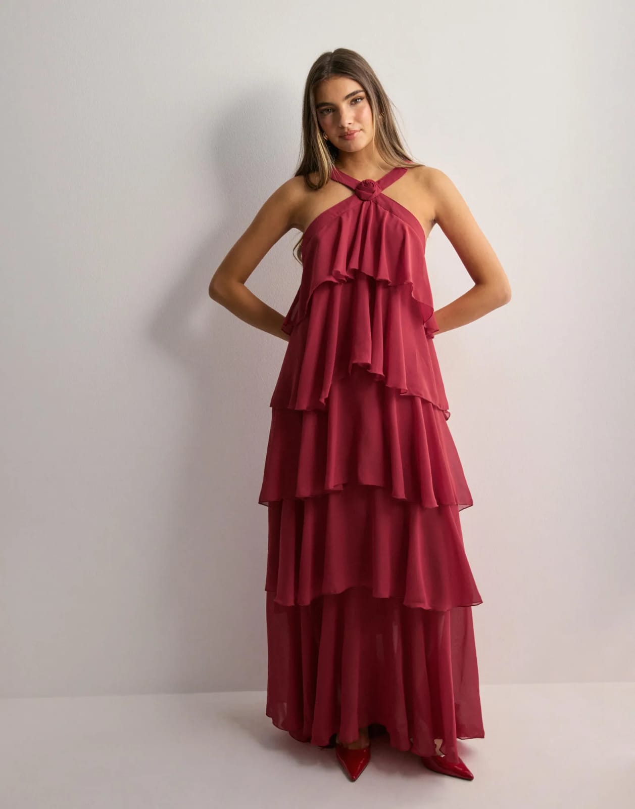 Yellow halter maxi dress with ruffled layers in outdoor field setting