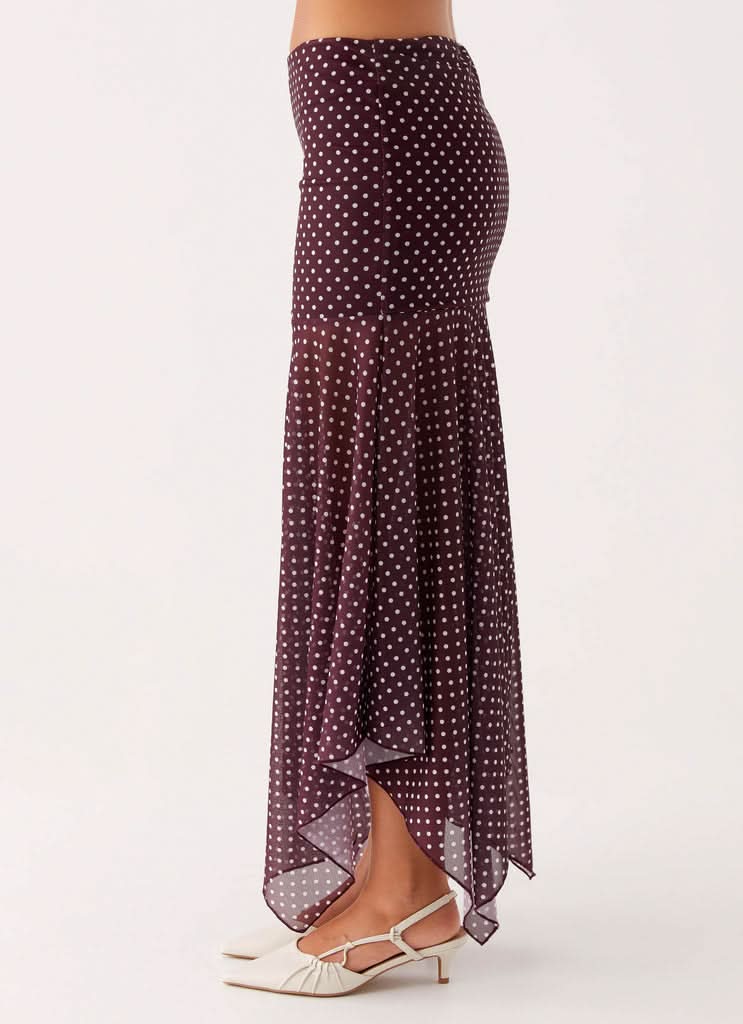 Burgundy polka dot maxi skirt with flowing asymmetrical handkerchief cut