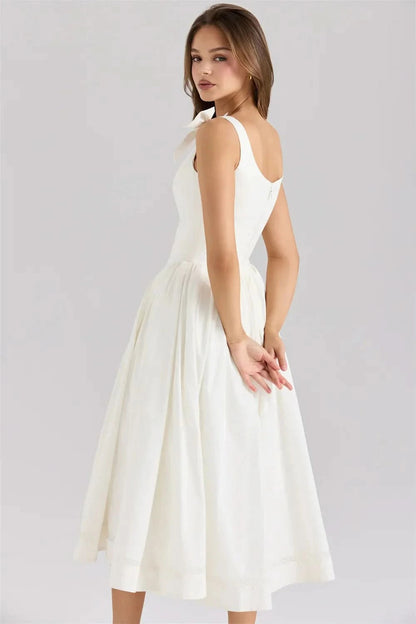 Back view of cream bow midi dress with open V-back design for women
