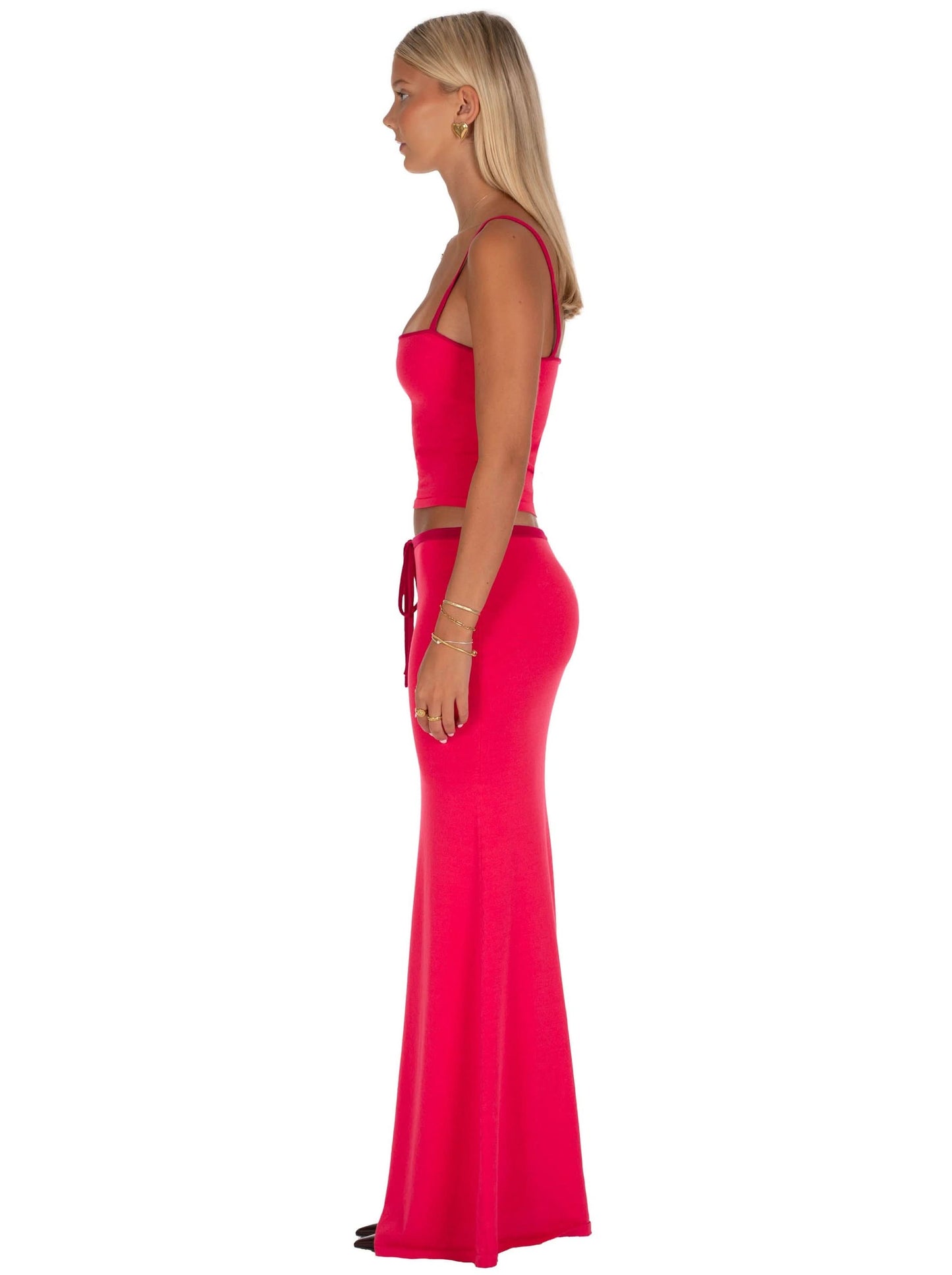 Side view of pink maxi set showing fitted crop top and flowing maxi skirt silhouette