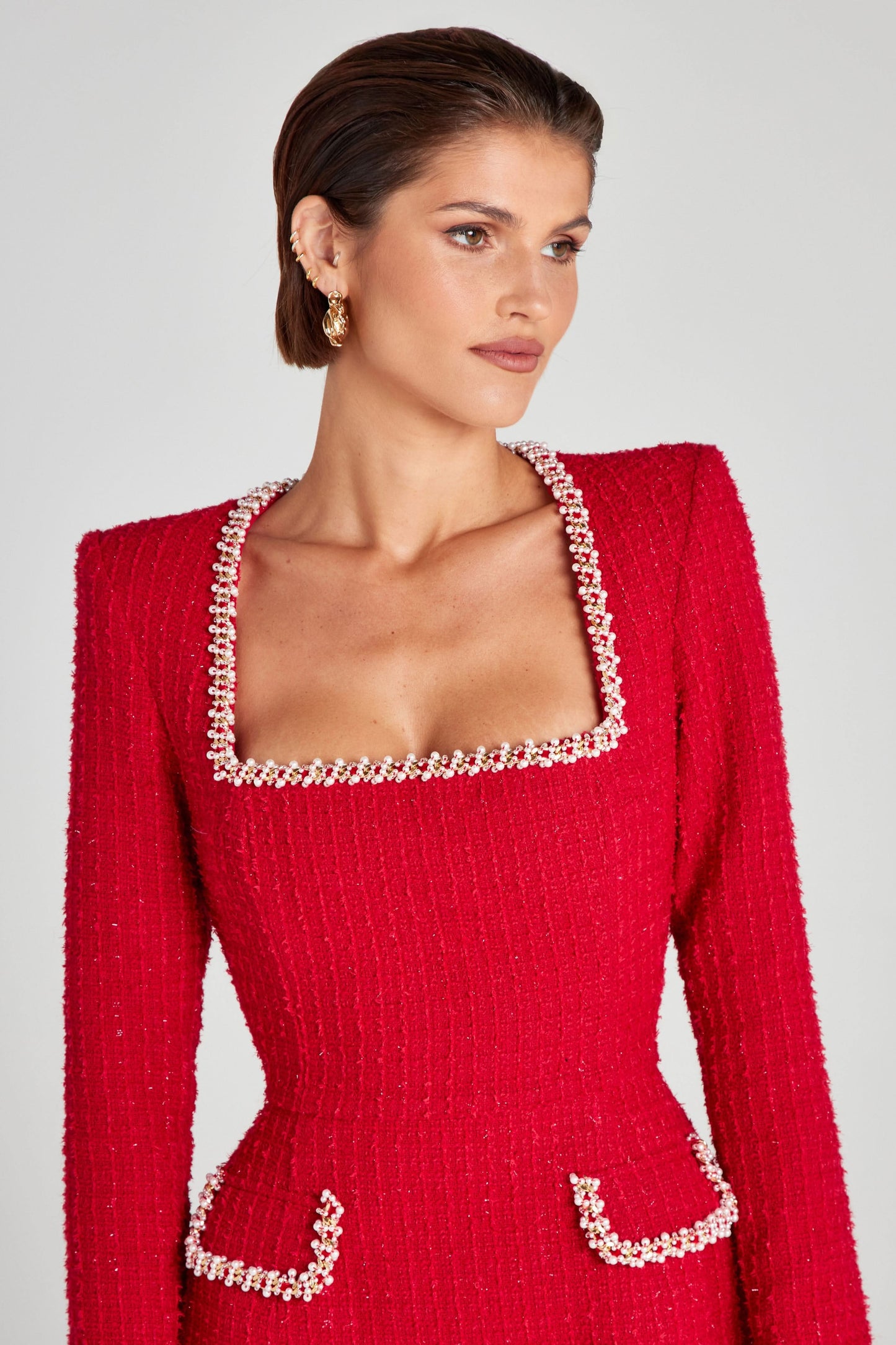 Close-up of red mini dress square neckline with pearl beading trim