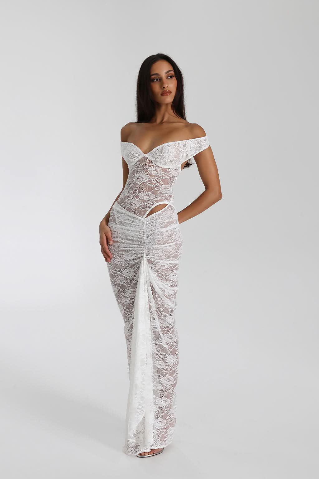 Front view of white lace maxi dress with off-shoulder neckline and cutout details
