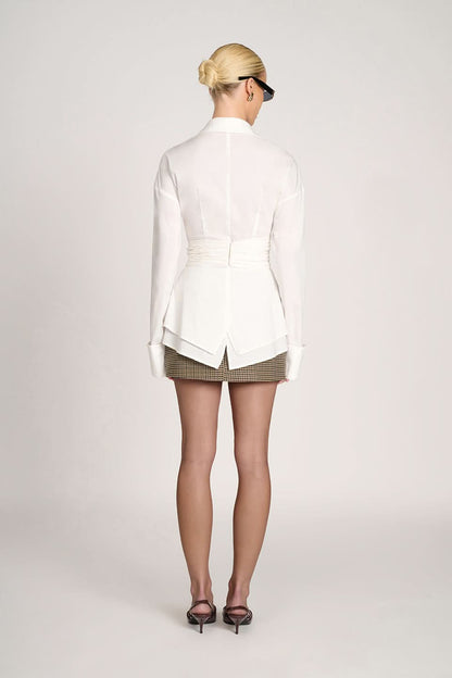 Close-up of brown blouse neckline and ruched waist cinching