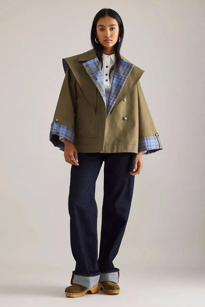 Double-breasted reversible trench blazer showing plaid lining and structured shoulders