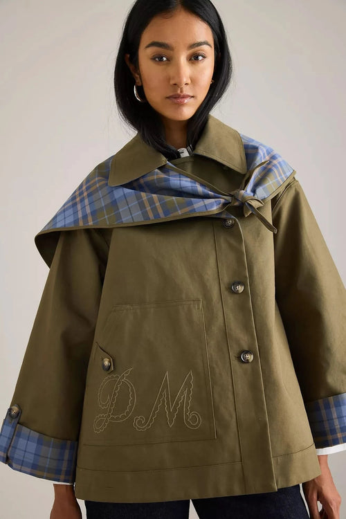 Olive reversible trench coat with blue plaid collar and embroidered detail