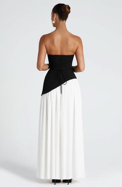 Back view of black and white color-block maxi dress with slit