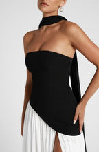 Side view of black and white asymmetric maxi dress with high slit