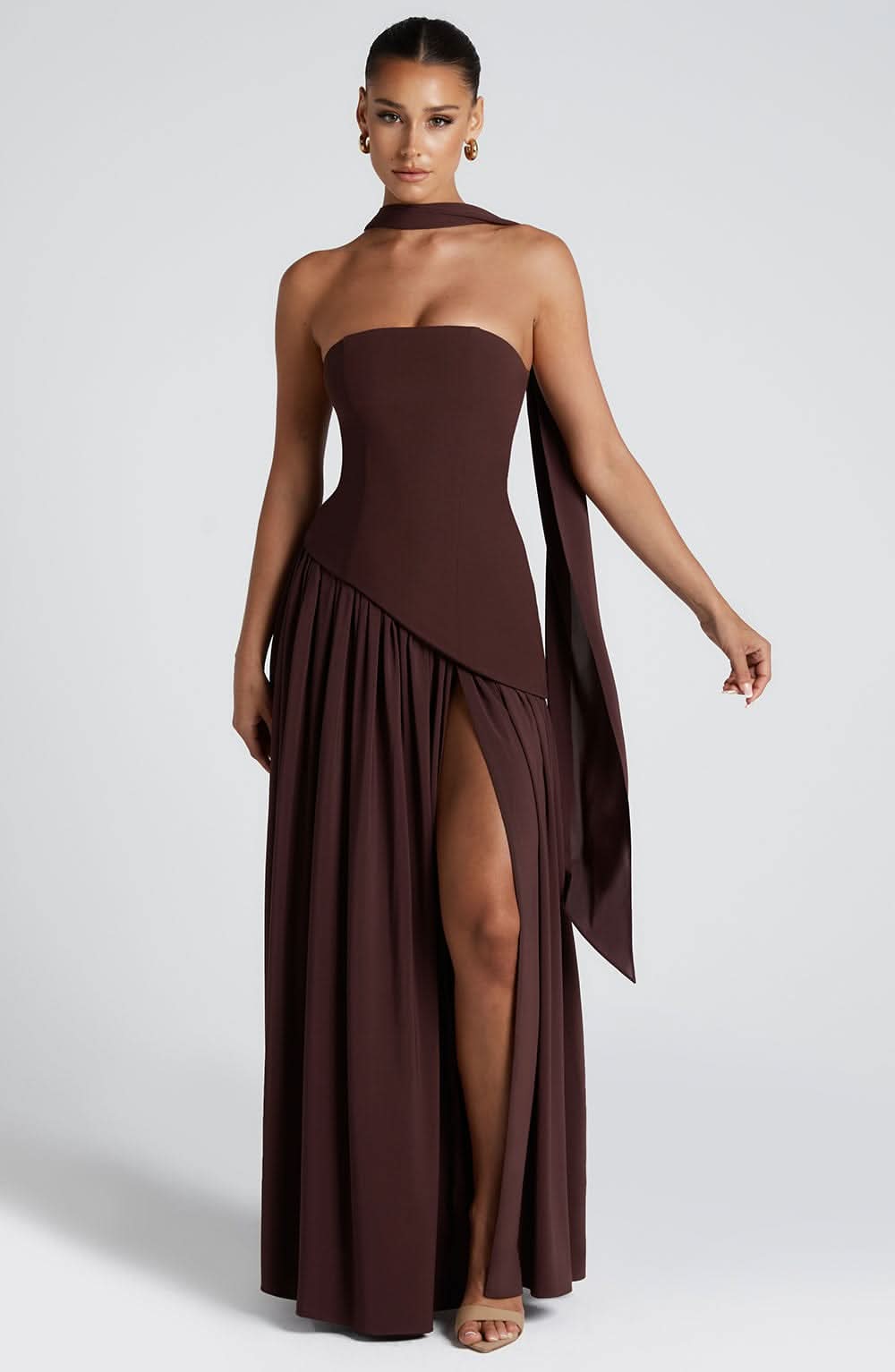 Brown strapless evening gown with diagonal pleated overlay and high slit