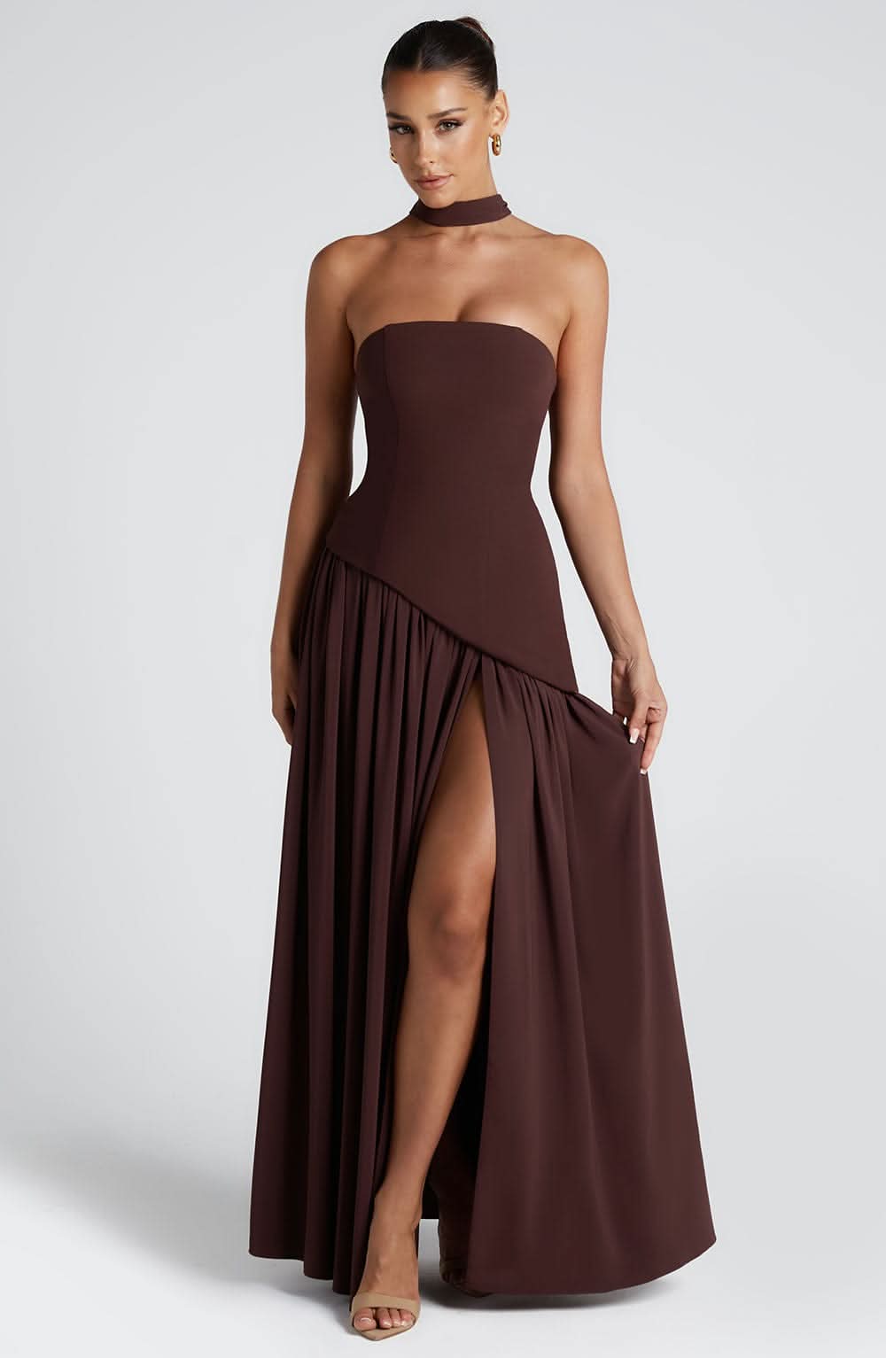 Brown strapless maxi dress with high leg slit and flowing pleated hem