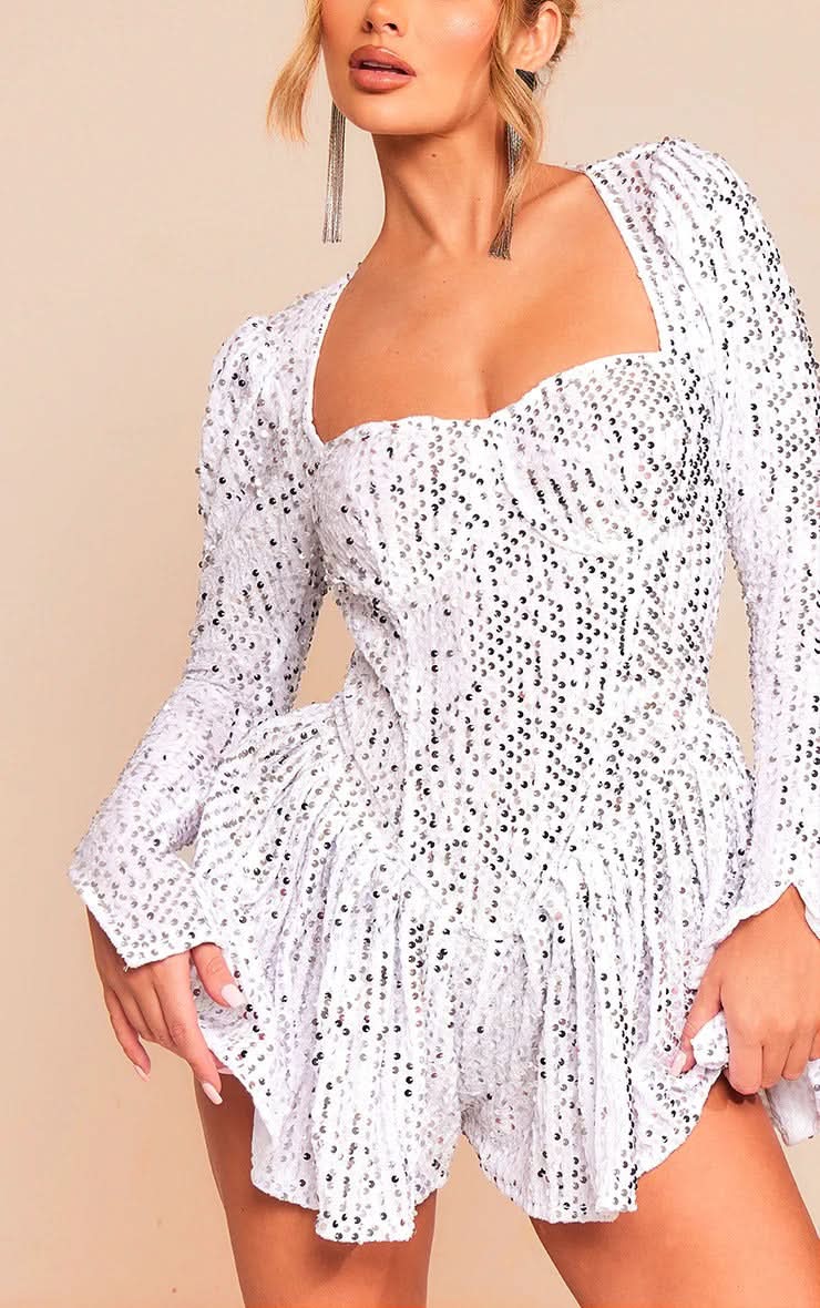 Close-up of white sequin dress neckline with puffed shoulder sleeve