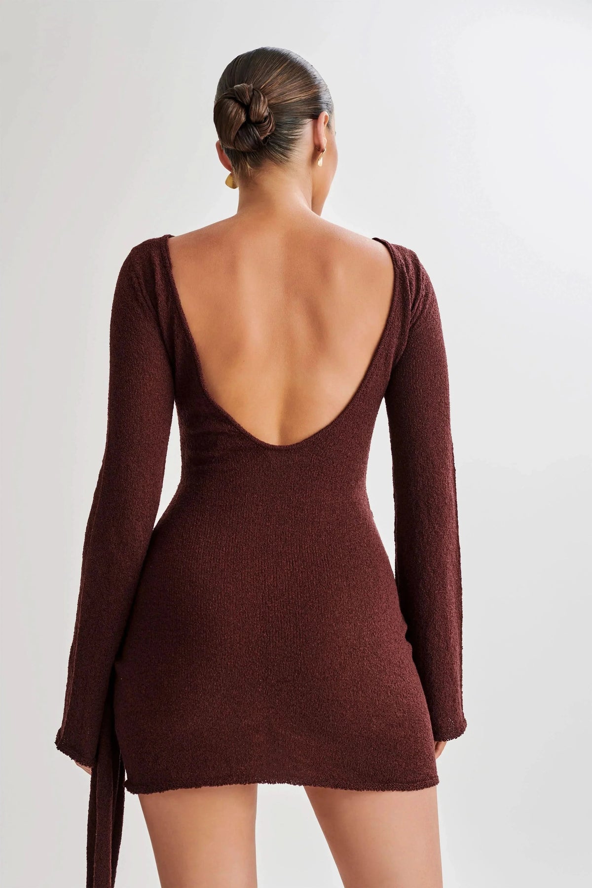 Back view of burgundy knitted mini dress with low scoop back detail