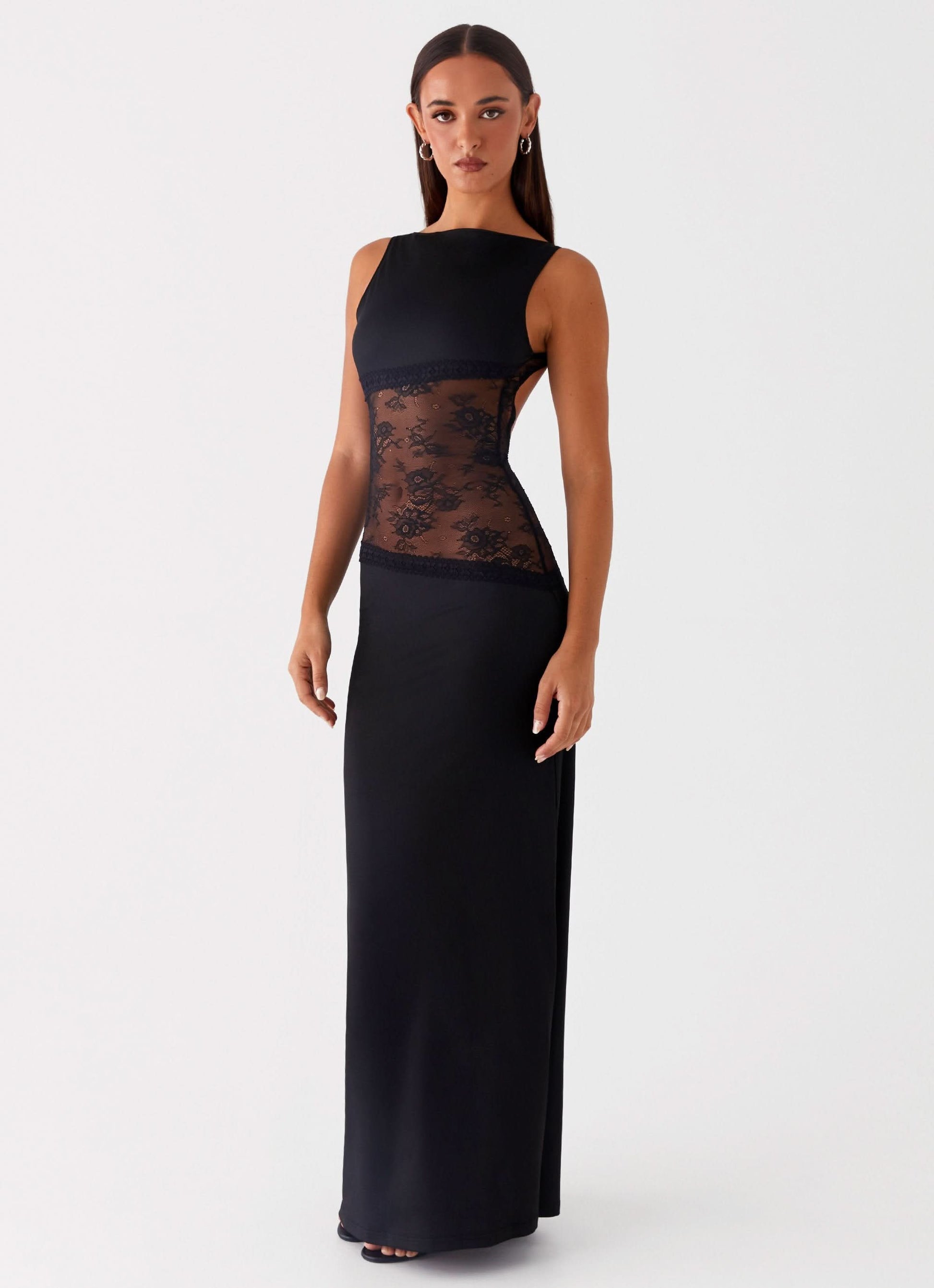 Side view of black maxi dress with lace cutout waist detail