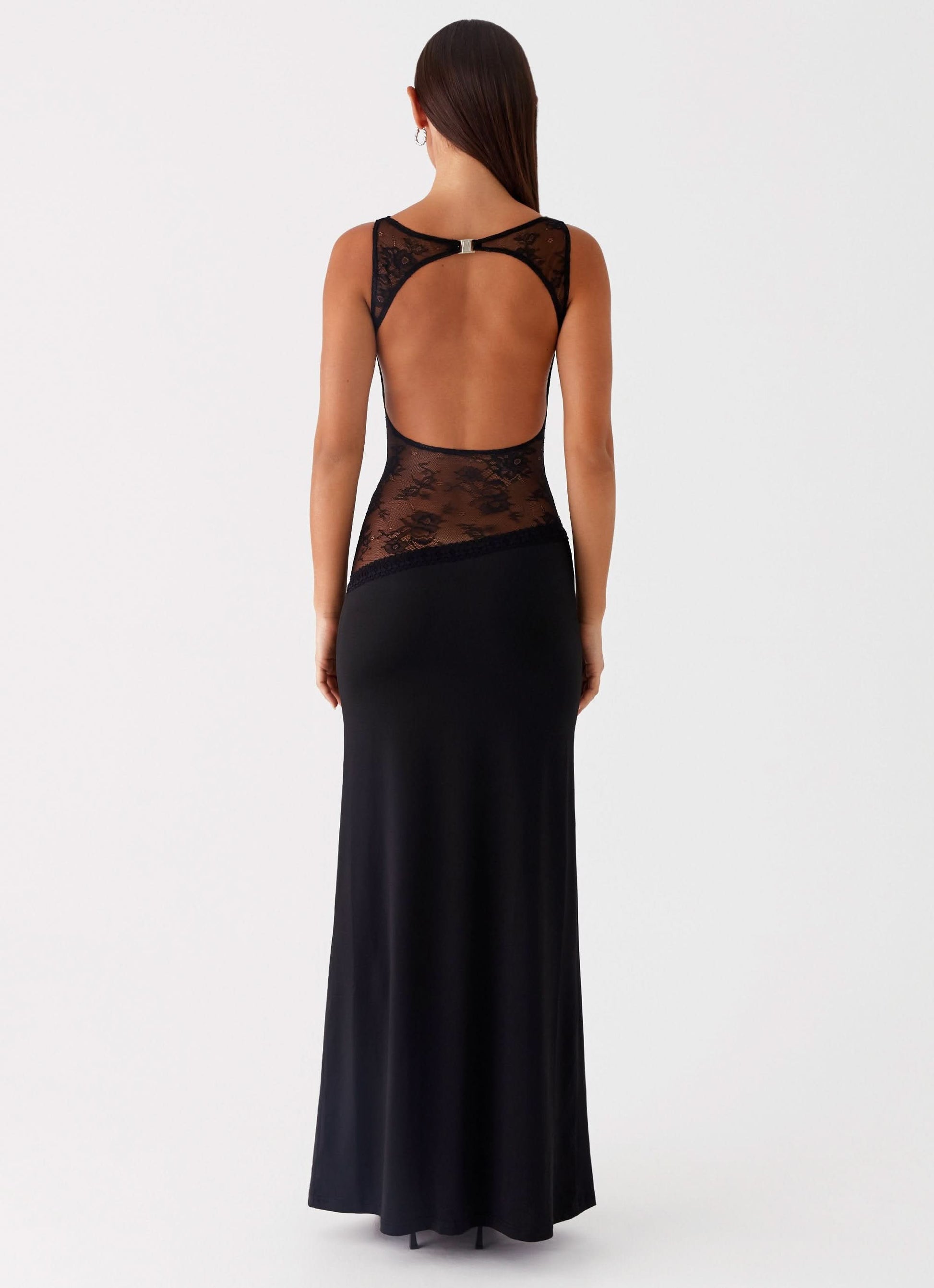 Back view of black maxi dress with open back and lace waist insert